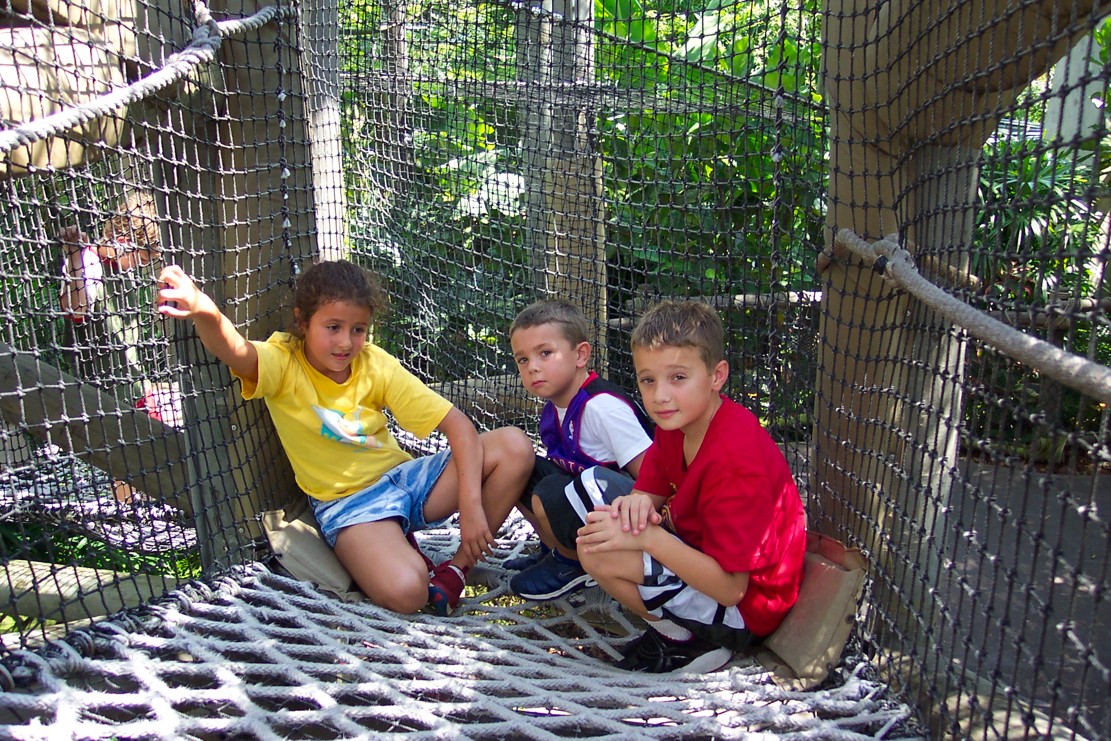 Anna, Jacob, and David on a hanging bridge in Jurassic Park at Adventure Island