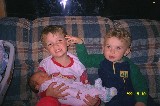 Jacob is holding his new born sister Rachel, while his brother David is assisting