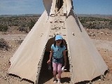 Rachel coming out of a teepee