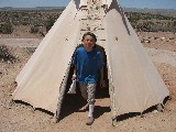 Claudia coming out of a tipi