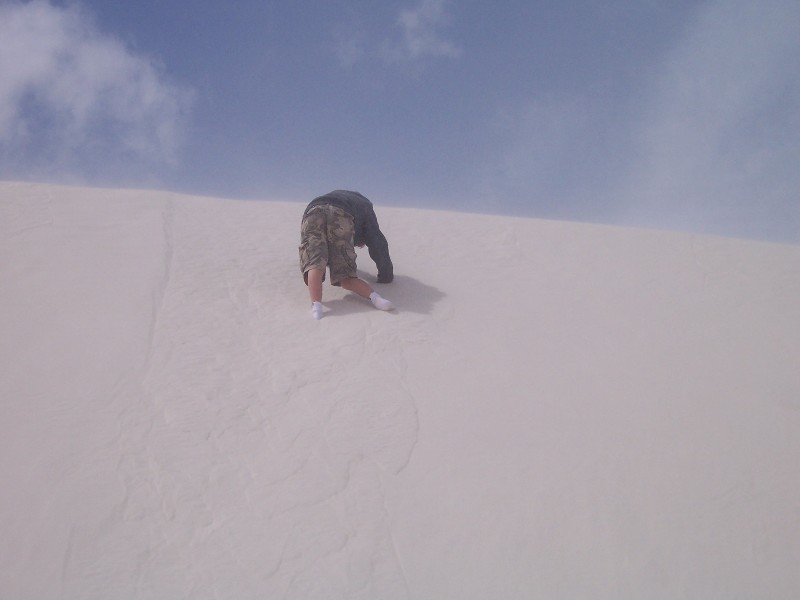 Jacob is climbing a sand dune