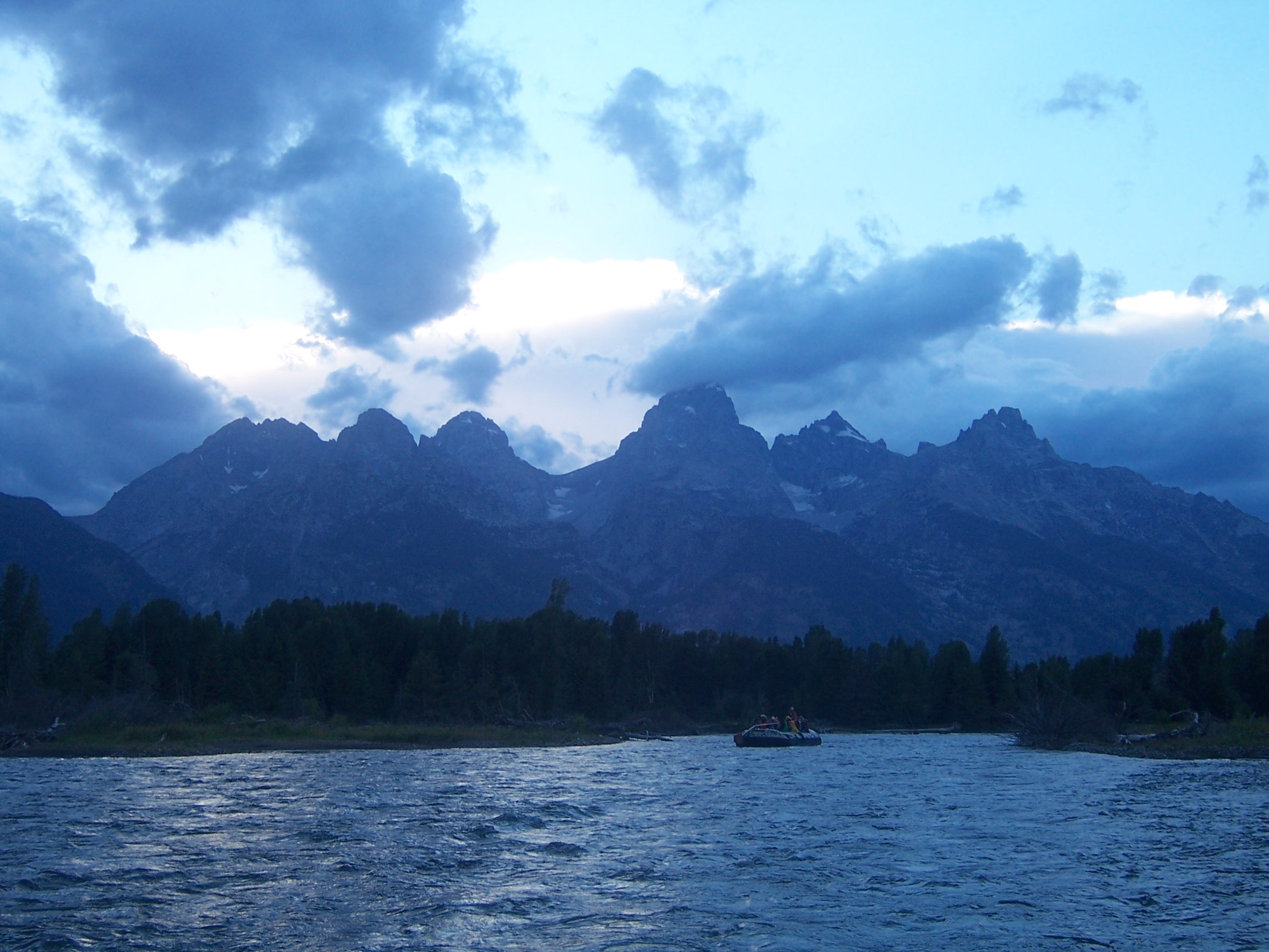Slow rafting on Snake River. Teton Range in the background. Bad weather coming.