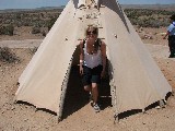 Emelie coming out of a tipi