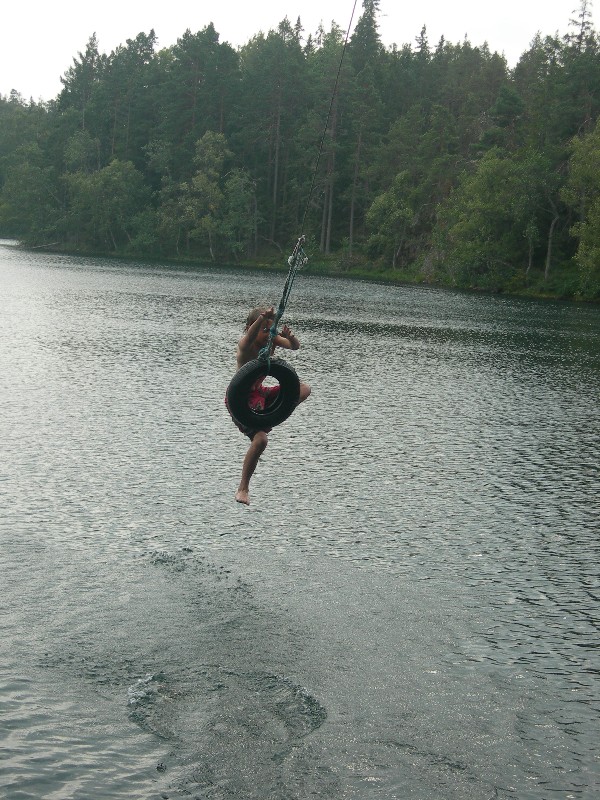 Jacob jumping from a tire into a cool North Swedish lake