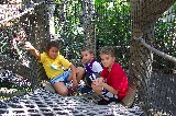 Anna, Jacob, and David on a hanging bridge in Jurassic Park at Adventure Island